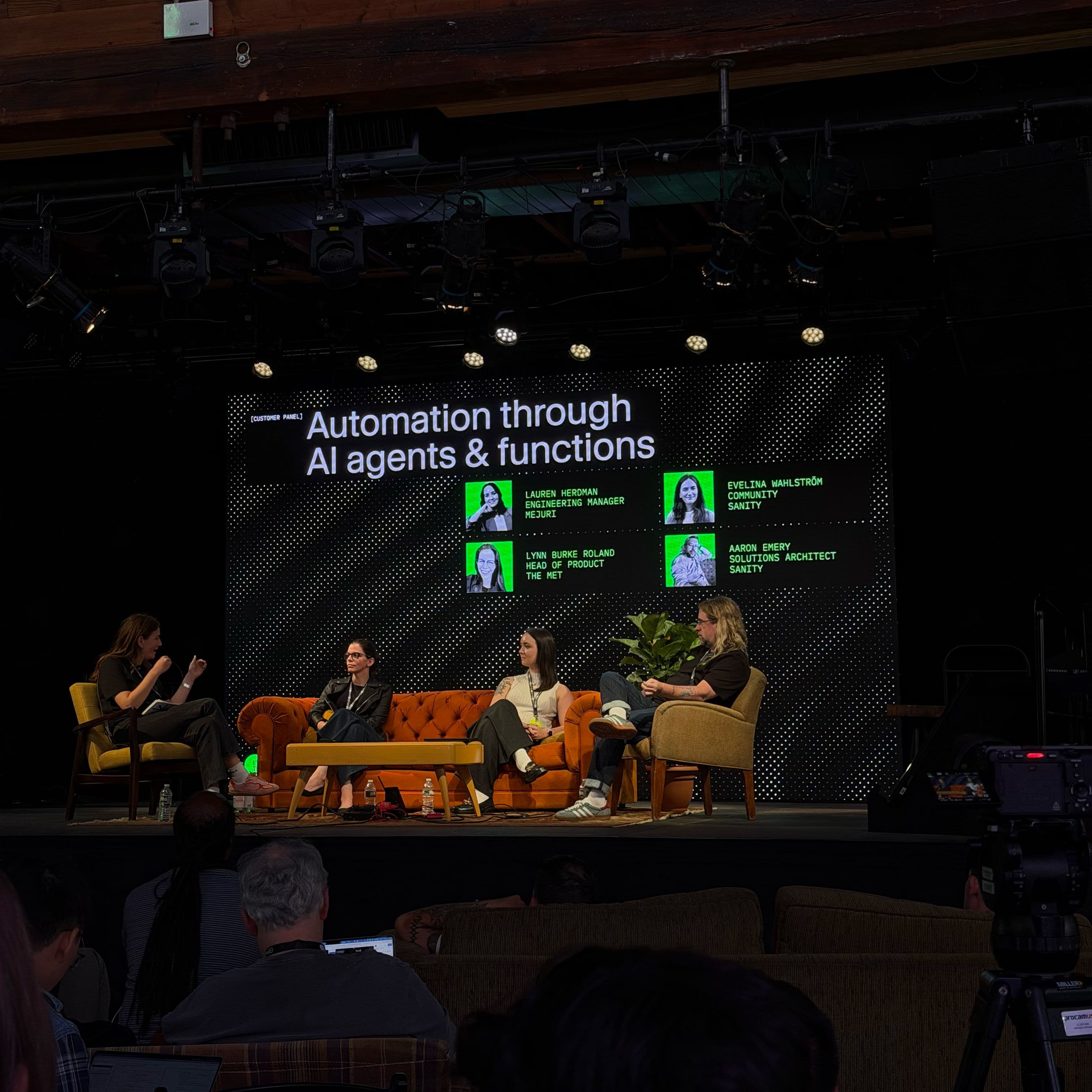 a group of people are sitting on a stage talking about automation through ai agents and functions